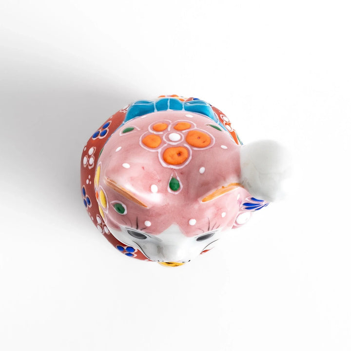Pink blossom Maneki Neko figurine with floral patterns and gold bell symbolizing good luck and prosperity.