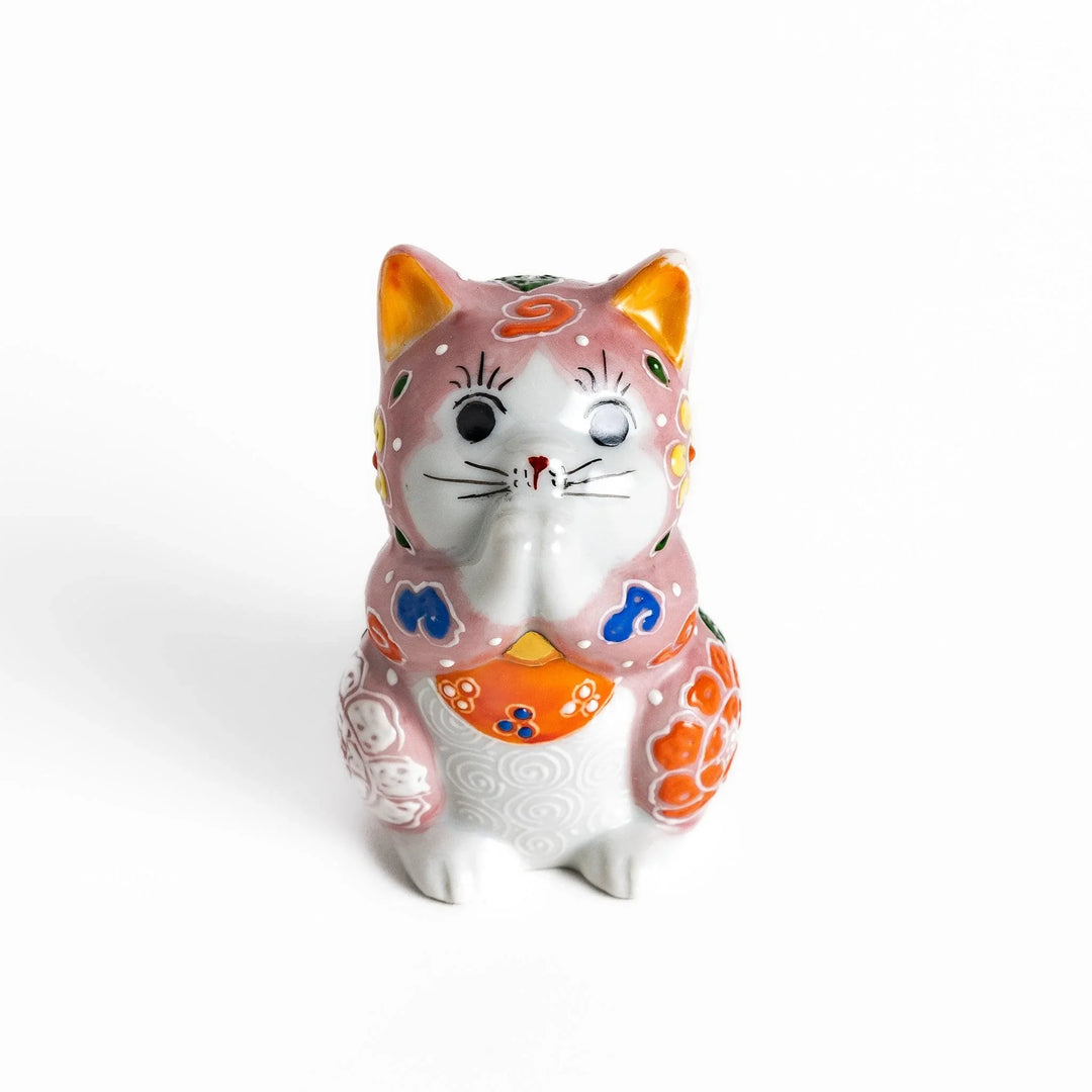 Maneki Neko figurine featuring a pink blossom design with vibrant colors and a praying posture for good fortune.