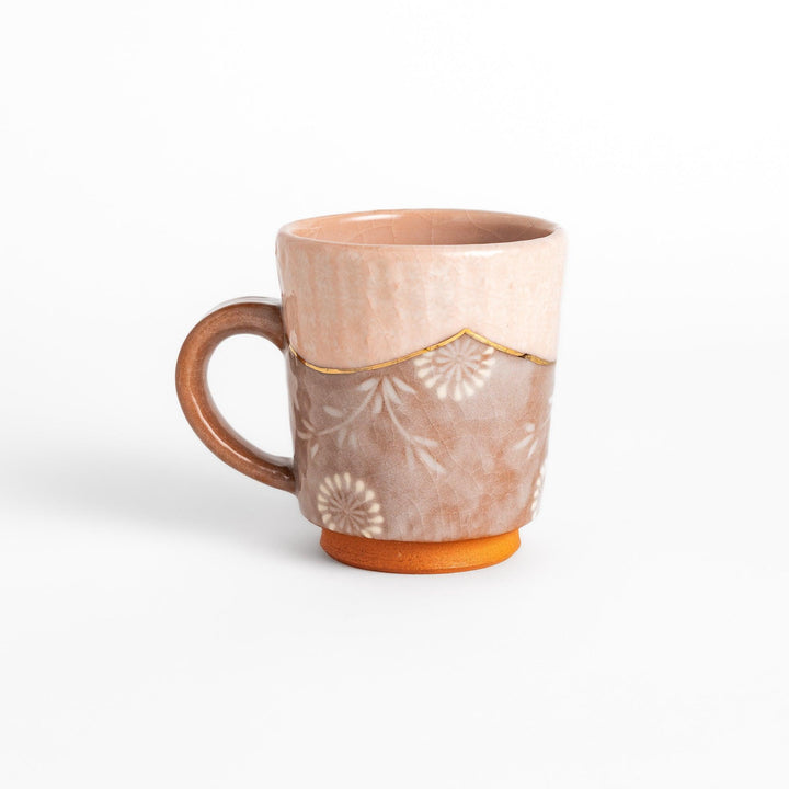 Elegant pink floral mug with a delicate design and gold detailing on the rim, perfect for enjoying hot beverages in style.