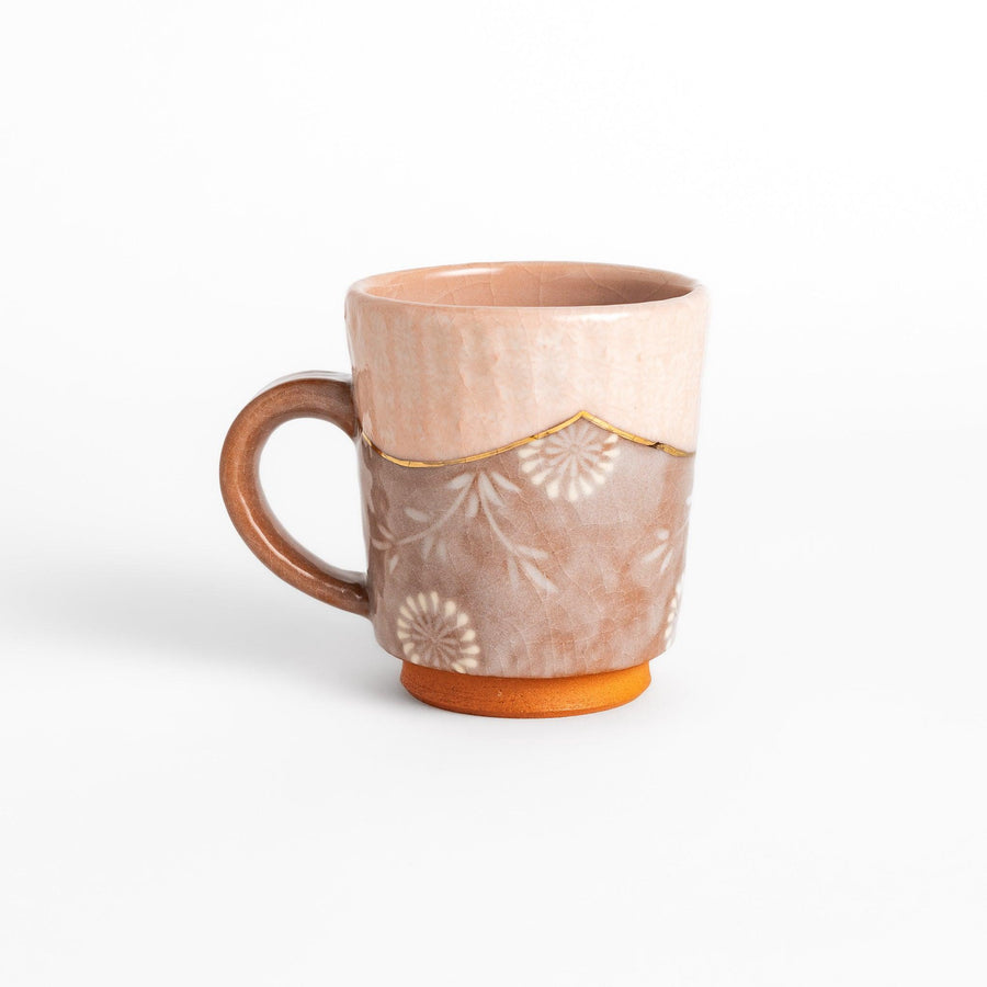 Elegant pink floral mug with a delicate design and gold detailing on the rim, perfect for enjoying hot beverages in style.