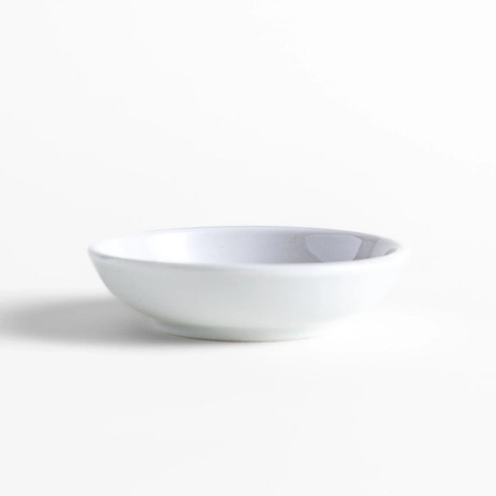 White ceramic Japanese incense holder with pink rose design adding elegant floral touch to any space.