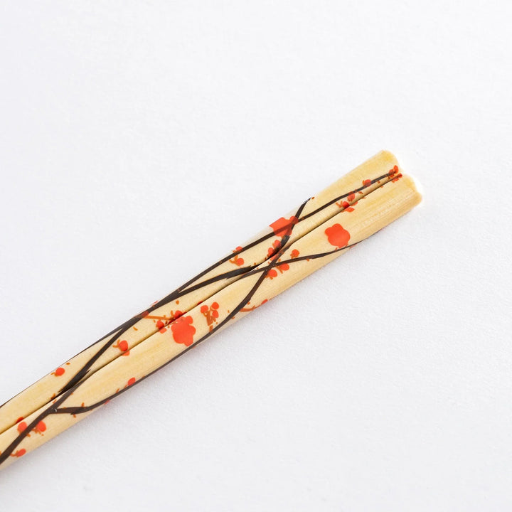 Chopsticks set in wooden gift box with blue interior and red green patterns showing Japanese artistry.