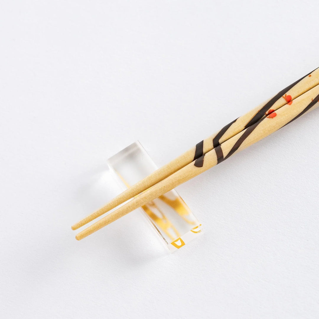Chopsticks set in wooden gift box with blue interior and red green patterns showing Japanese artistry.