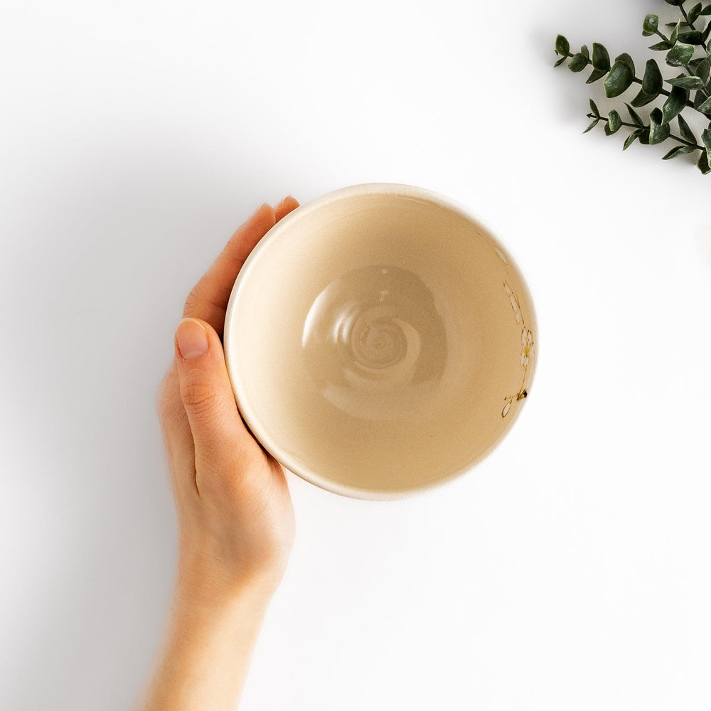 Plum Blossom Matcha Bowl with pink floral designs on a cream surface, adding elegance to your matcha moments.