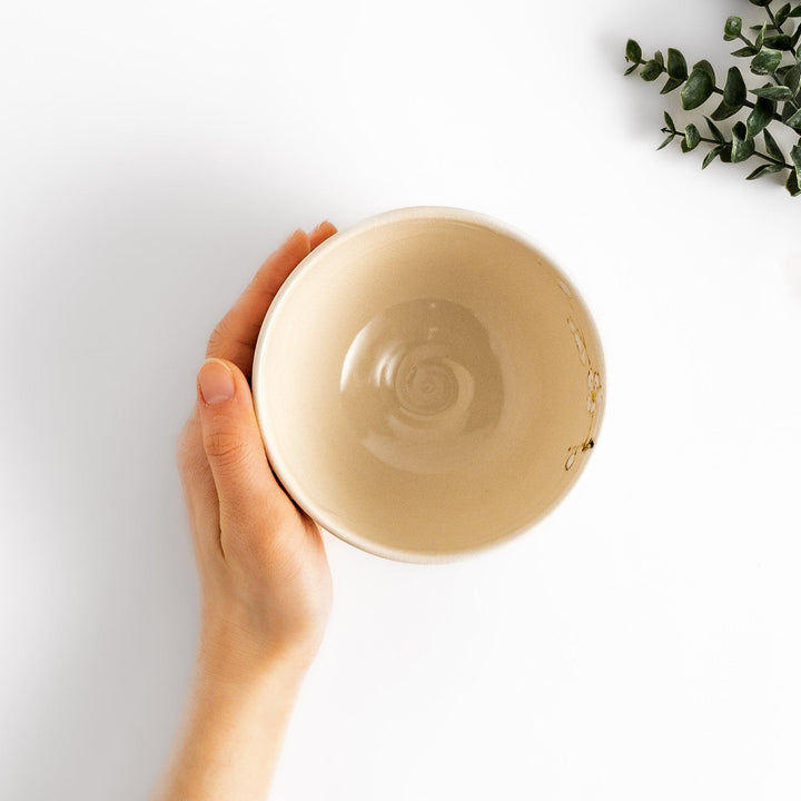 Plum Blossom Matcha Bowl with pink floral designs on a cream surface, adding elegance to your matcha moments.