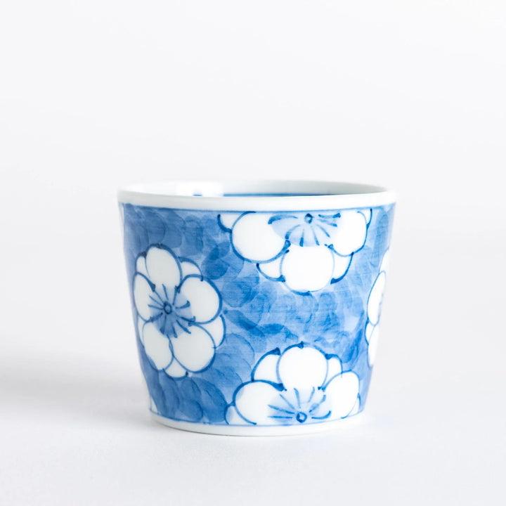 A small porcelain condiment bowl adorned with a blue floral pattern and soft brush strokes.