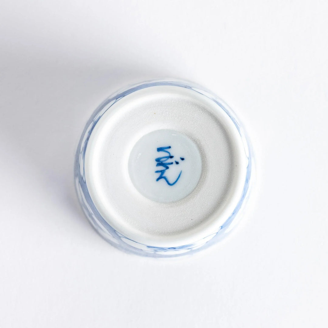 A small porcelain condiment bowl adorned with a blue floral pattern and soft brush strokes.