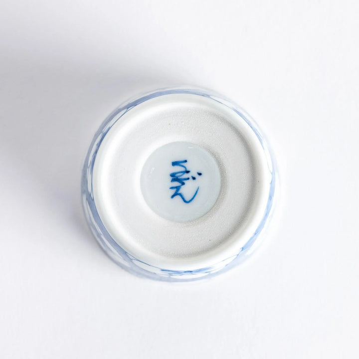 A small porcelain condiment bowl adorned with a blue floral pattern and soft brush strokes.