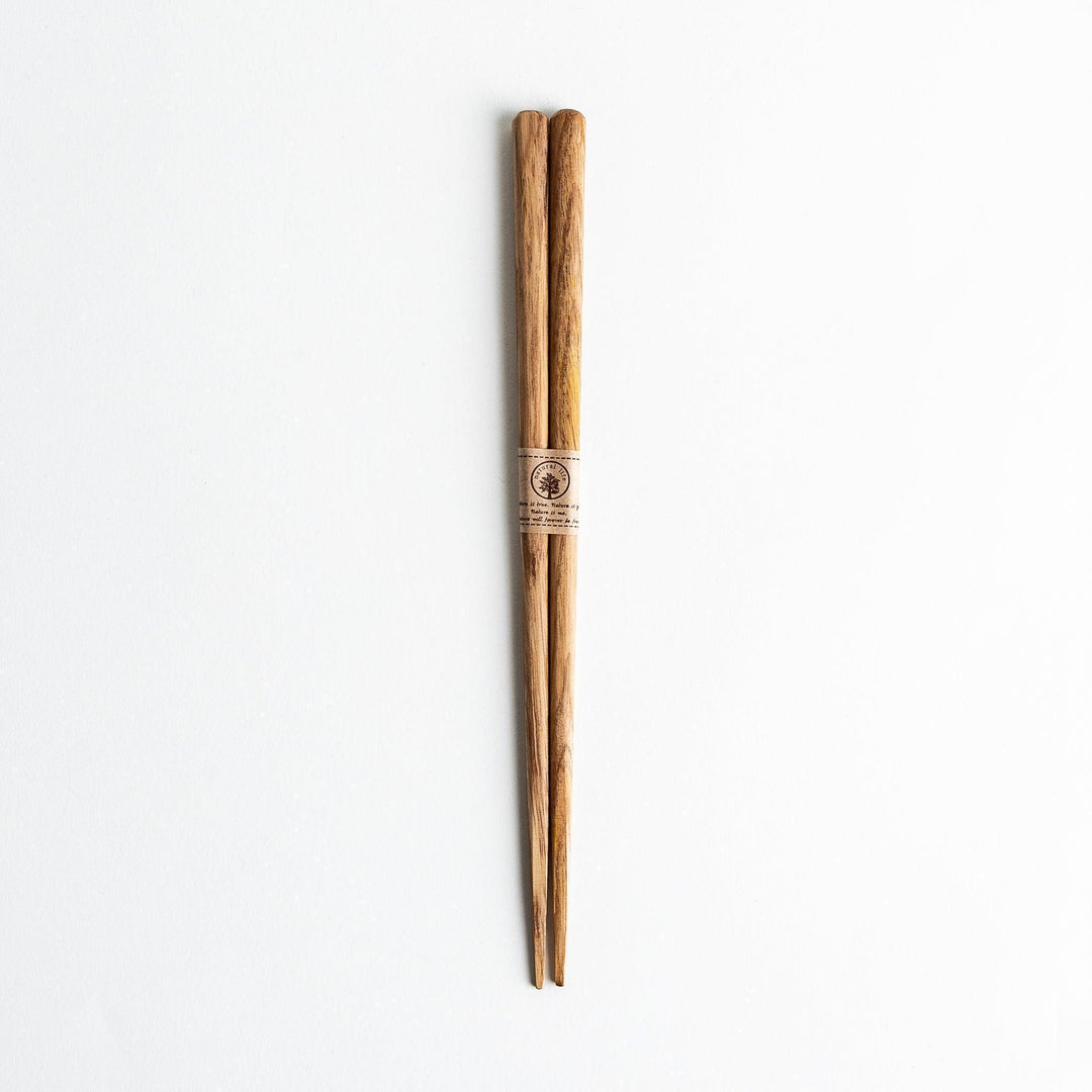 Three pairs of natural chestnut wood chopsticks, each with a different geometric shape—triangle, hexagon, and round.