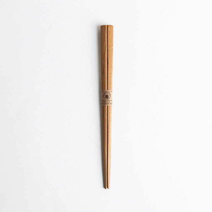 Three pairs of natural chestnut wood chopsticks, each with a different geometric shape—triangle, hexagon, and round.