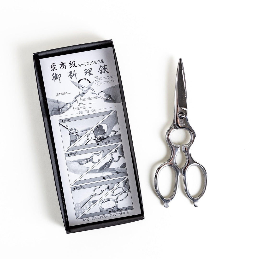 Silver kitchen shears with detachable blades and sleek design ideal for precise cutting and cleaning.