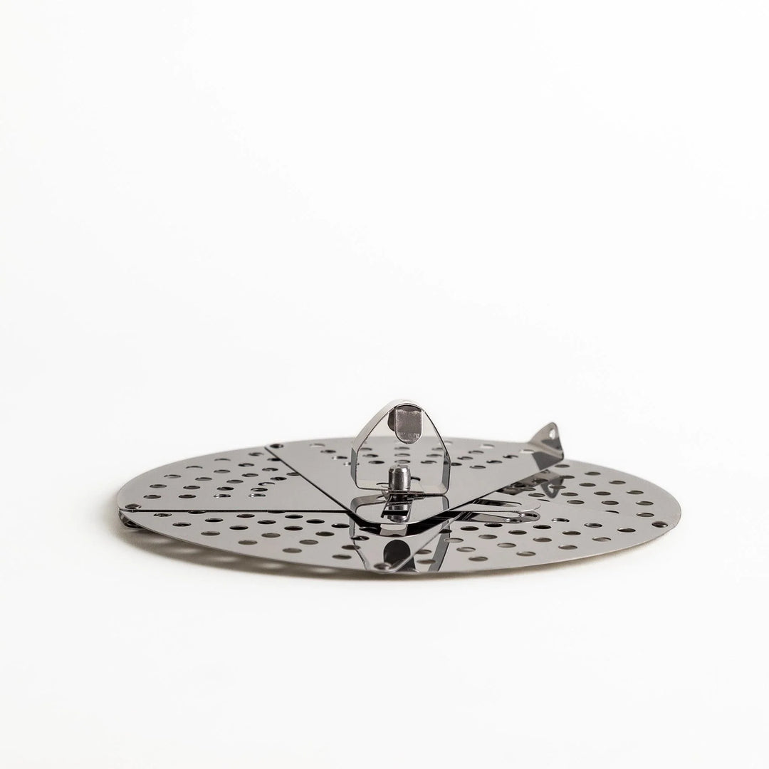 Adjustable stainless steel drop lid with foldable petals for steaming simmering and boil over control.