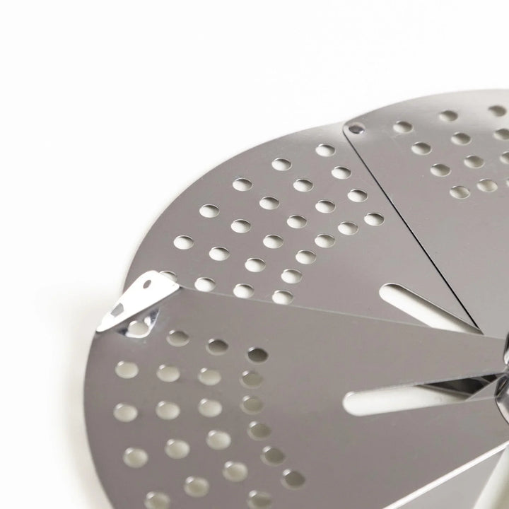 Adjustable stainless steel drop lid with foldable petals for steaming simmering and boil over control.