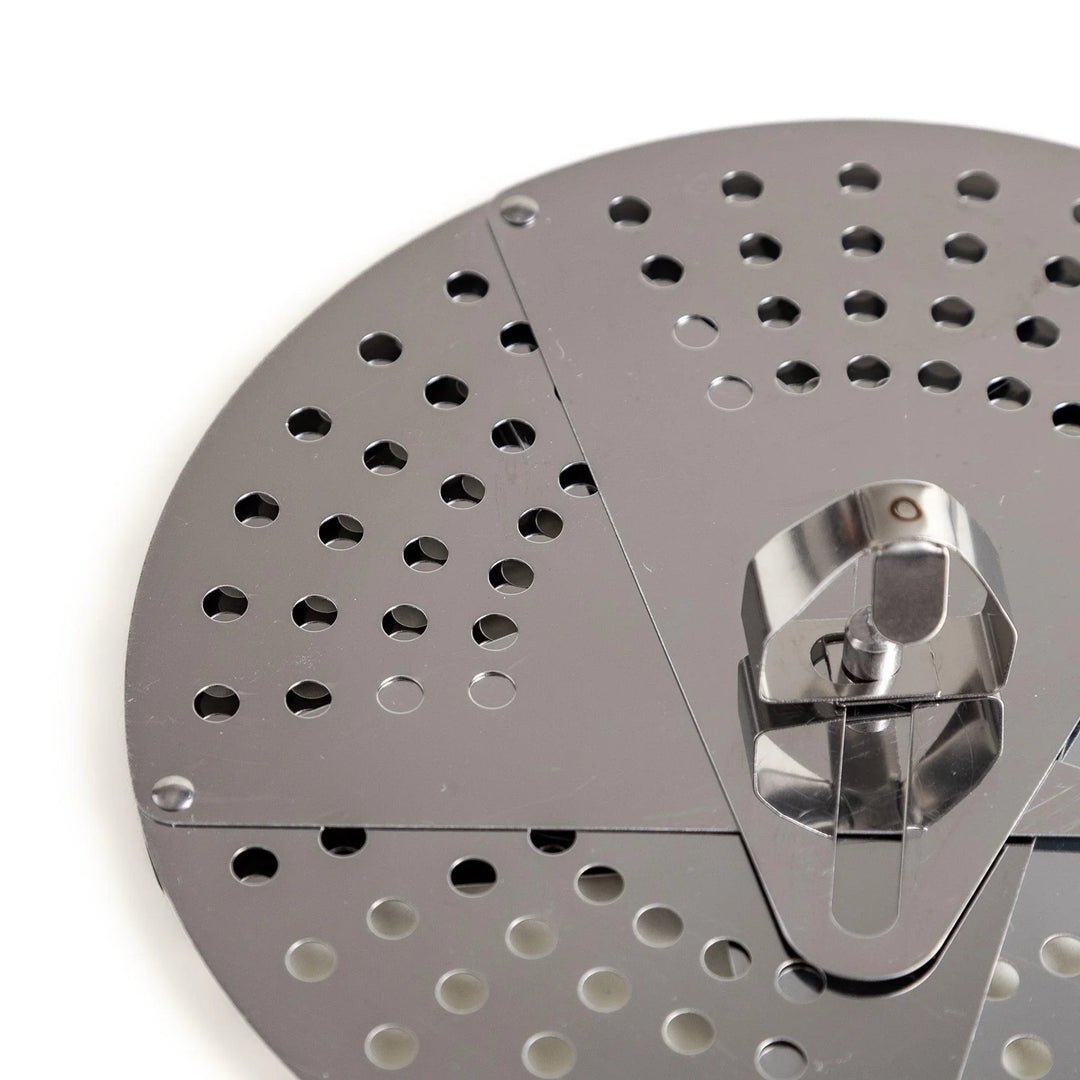 Adjustable stainless steel drop lid with foldable petals for steaming simmering and boil over control.