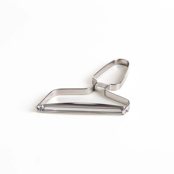 Stainless steel peeler with sharp blade and ergonomic handle for peeling fruits and vegetables easily.