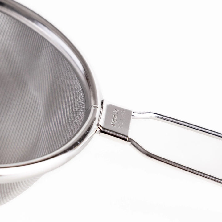 Stainless steel tea strainer with a fine mesh and a long handle, an essential kitchenware tool for brewing loose leaf tea.