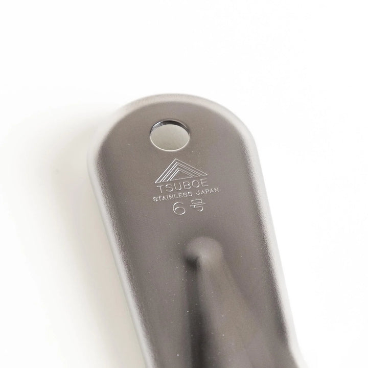 Stainless steel grater with sharp blades and ergonomic handle ideal for cheese vegetables and spices.