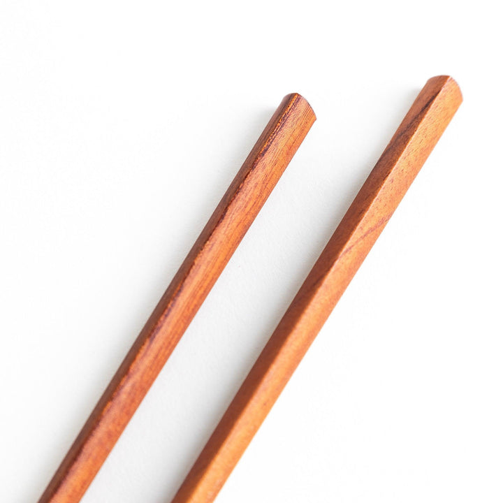 Three pairs of natural zelkova wood chopsticks, each with a different geometric shape—triangle, hexagon, and round.
