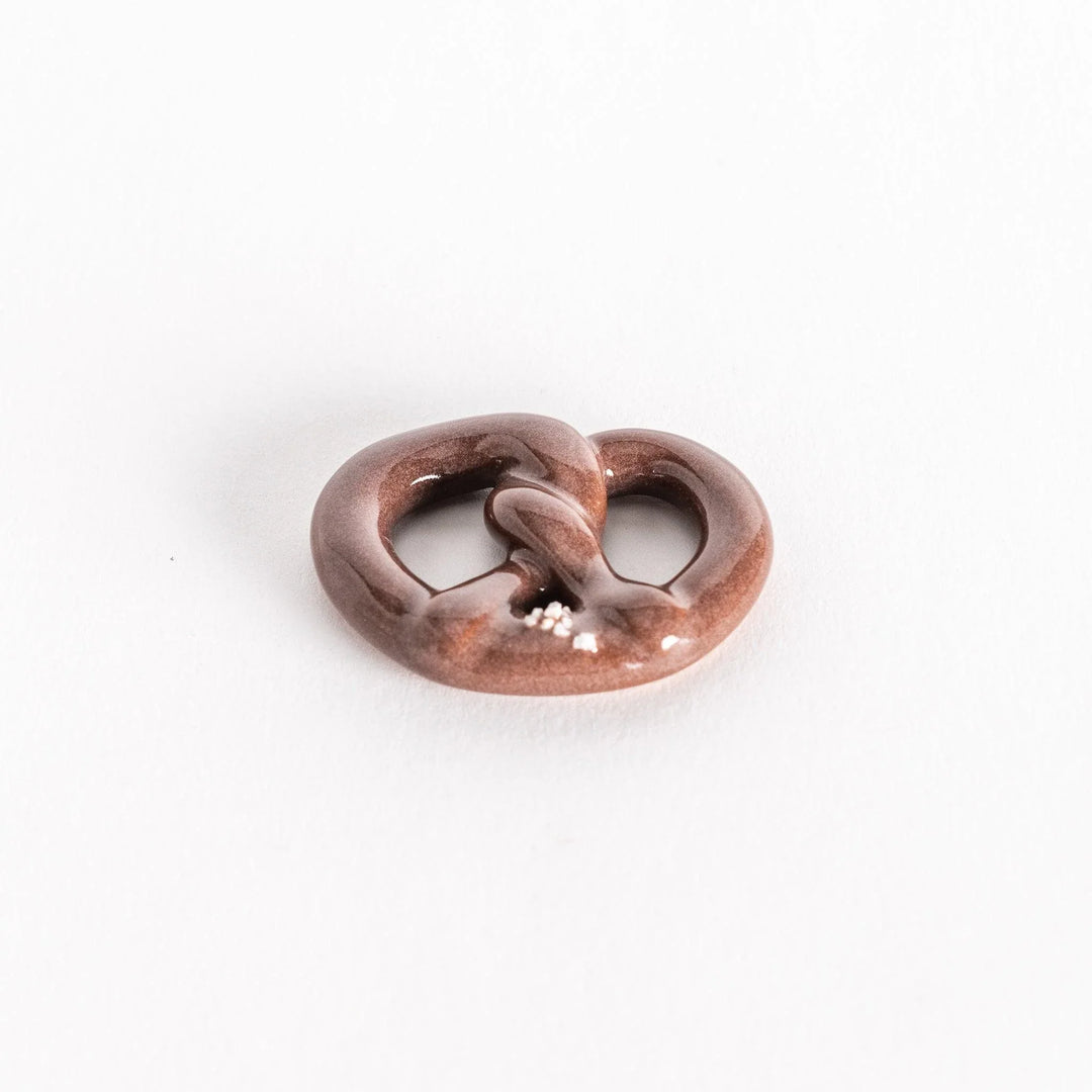 Angled view highlighting the pretzel’s rounded shape and details.
