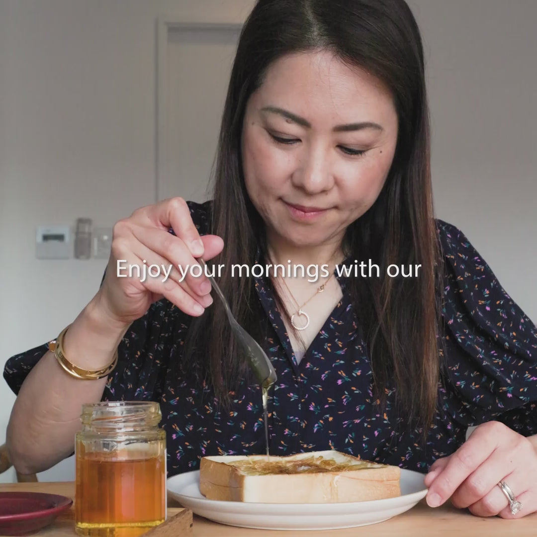 Drizzling honey onto toast with a stainless steel japanese honey spoon featuring a v shaped scoop design