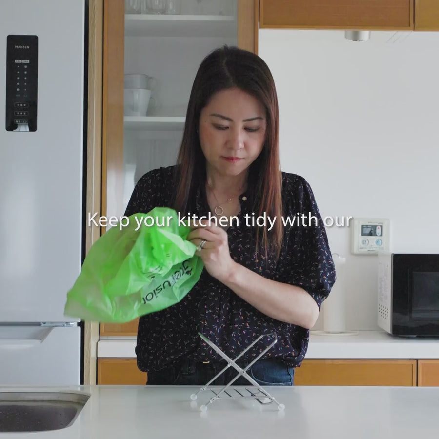 Using a collapsible stainless steel compost bag holder for collecting kitchen food waste scraps on the counter