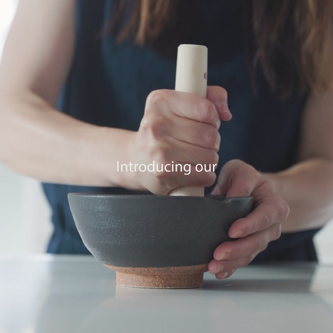 Nami from Just One Cookbook grinding sesame seeds with Japanese suribachi mortar and wooden pestle in kitchen