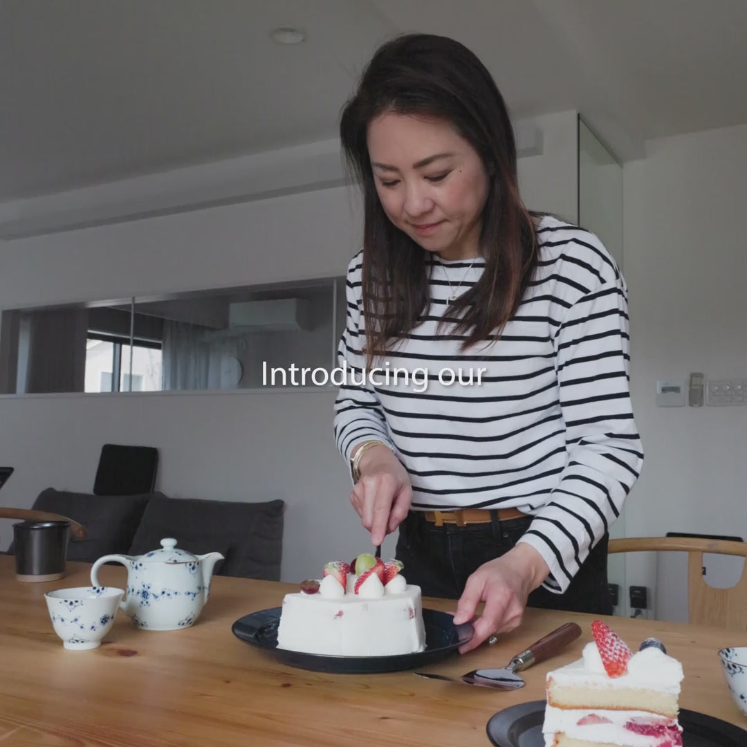 Nami from Just One Cookbook demonstrating the Nagomi cake knife and server set to cut and serve a strawberry cake elegantly