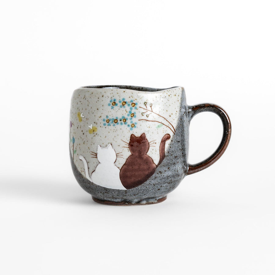 Charming Mug featuring two cats sitting together, surrounded by blooming flowers and birds.