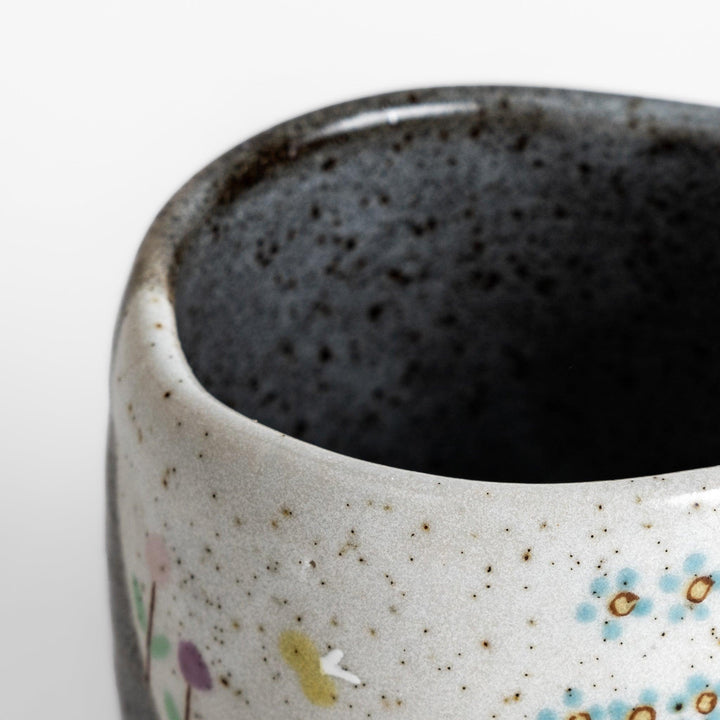 Charming Mug featuring two cats sitting together, surrounded by blooming flowers and birds.