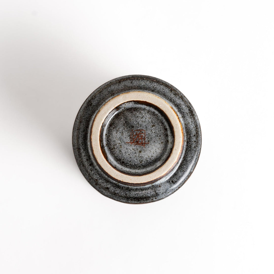 Ceramic teacup with two cats gazing at flowers speckled glaze and gentle shape for cozy tea time.