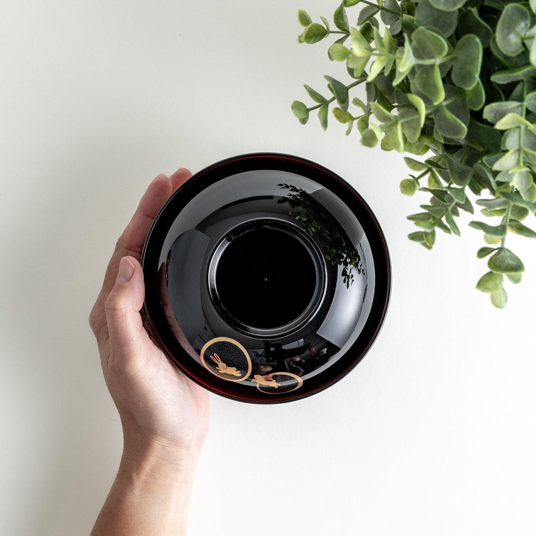 Lacquered soup bowls with lids, featuring golden vine designs. Available in red or black.