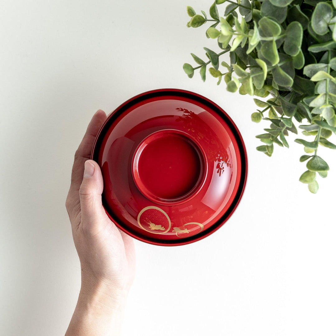 Lacquered soup bowls with lids, featuring golden vine designs. Available in red or black.