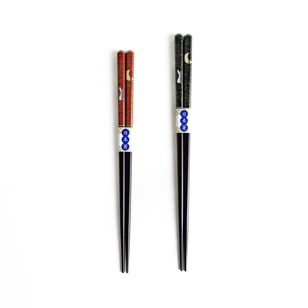 Boxed set of two Japanese chopstick pairs with red and green rabbit and moon patterns on the handles.
