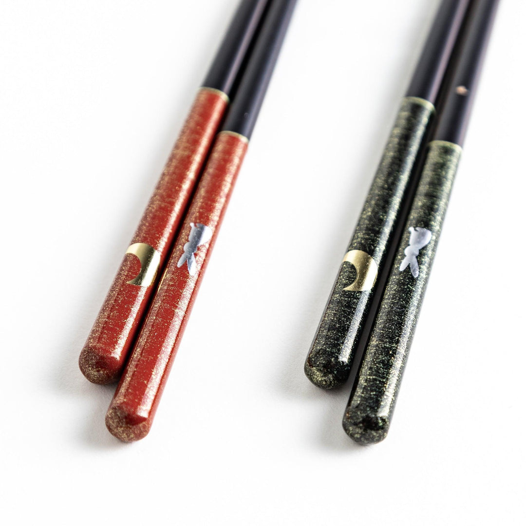 Boxed set of two Japanese chopstick pairs with red and green rabbit and moon patterns on the handles.