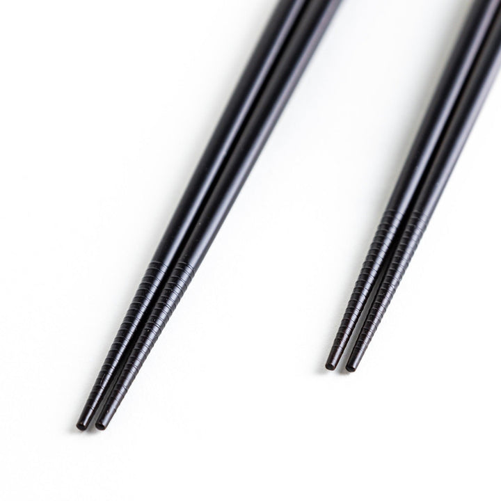 Boxed set of two Japanese chopstick pairs with red and green rabbit and moon patterns on the handles.