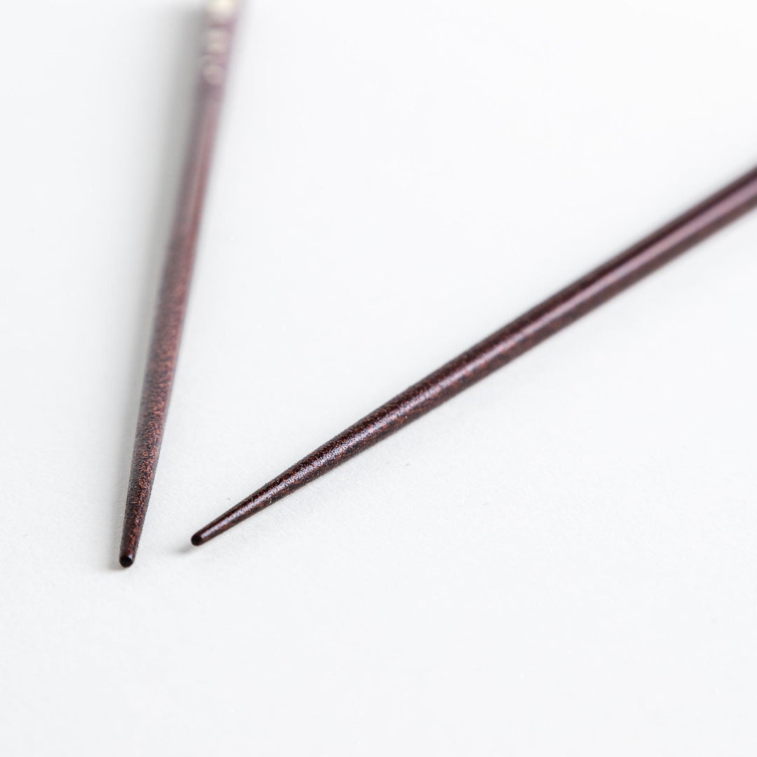 A pair of lacquered chopsticks adorned with floral patterns and rabbit. Available in purple or red.