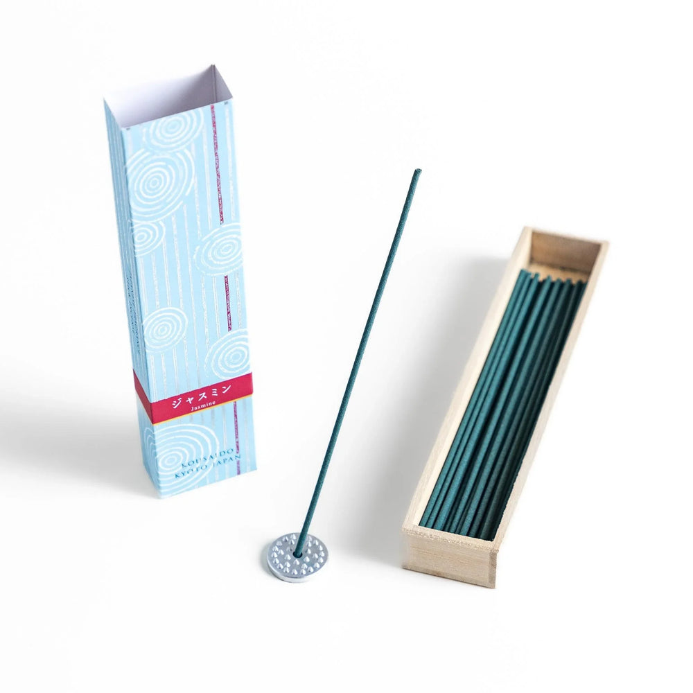 Japanese jasmine incense in wooden box with teal sticks and white circle pattern design for fresh floral scent.