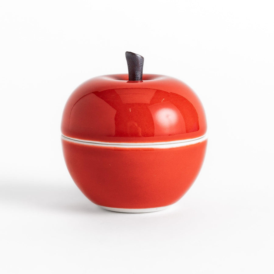 Red apple shaped ceramic condiment bowl with glossy finish and lid perfect for sauces or condiments.