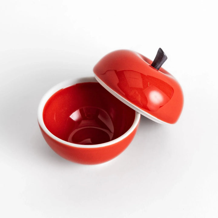 Red apple shaped ceramic condiment bowl with glossy finish and lid perfect for sauces or condiments.