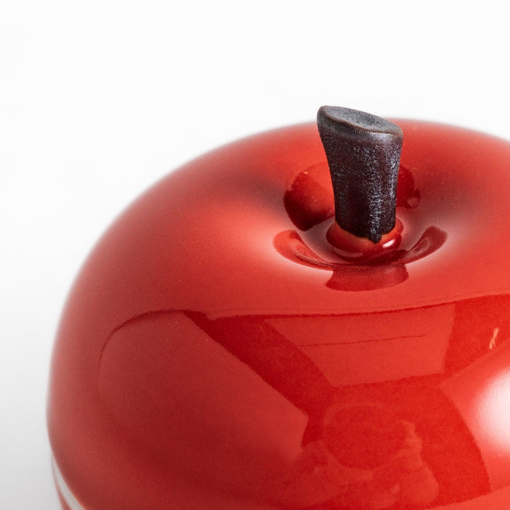Red apple shaped ceramic condiment bowl with glossy finish and lid perfect for sauces or condiments.