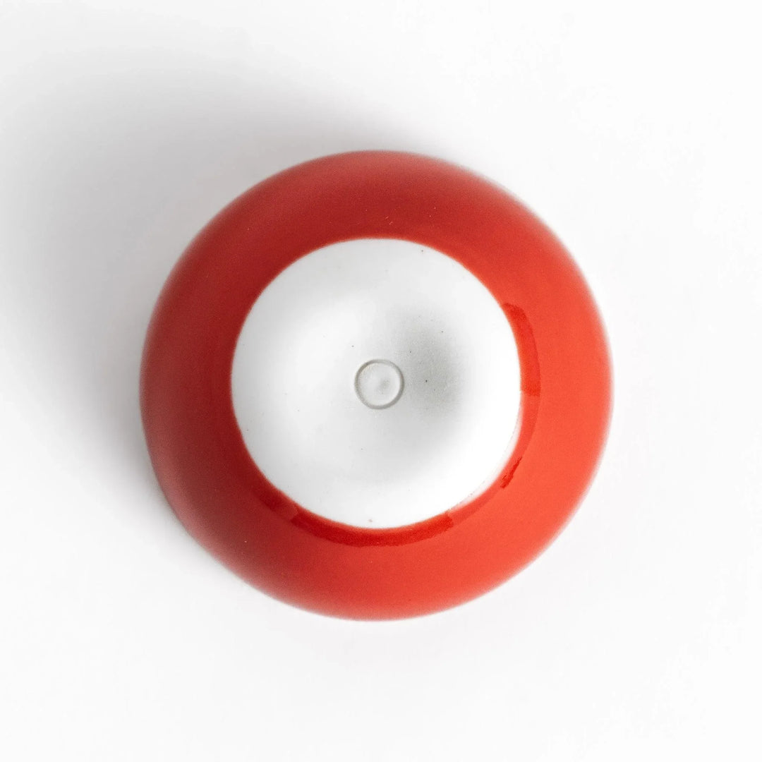 Red apple shaped ceramic condiment bowl with glossy finish and lid perfect for sauces or condiments.