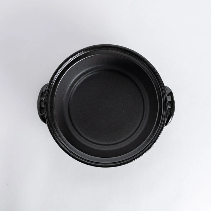 A 8-inch donabe with a vibrant red blossom pattern lid and black pot.