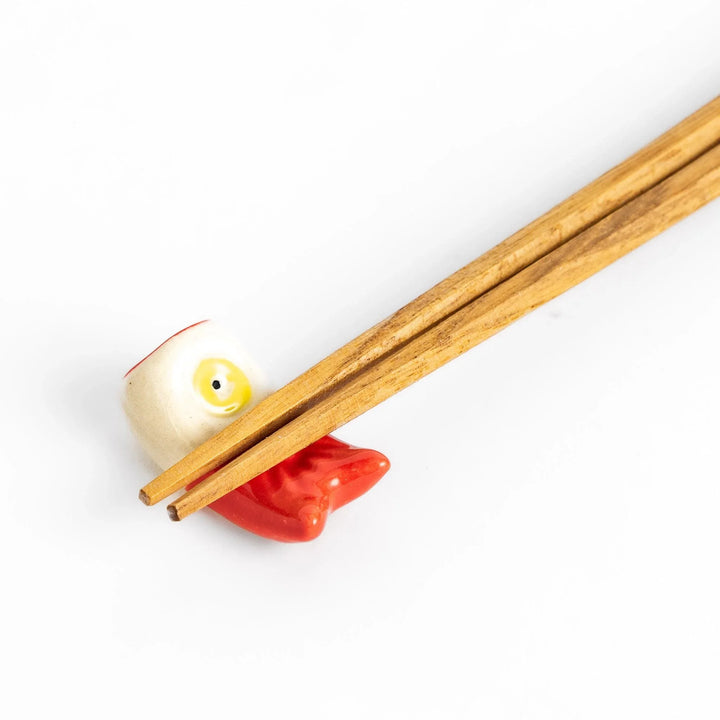 Chopstick rest shaped like a red carp streamer with intricate details and a playful, colorful design.