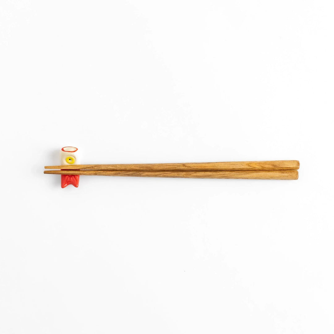Chopstick rest shaped like a red carp streamer with intricate details and a playful, colorful design.