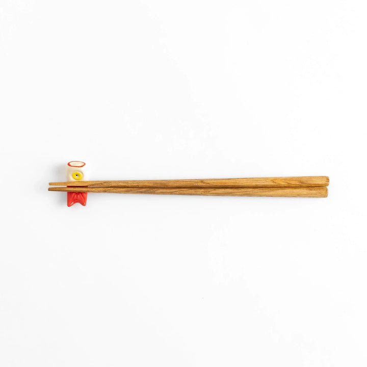 Chopstick rest shaped like a red carp streamer with intricate details and a playful, colorful design.