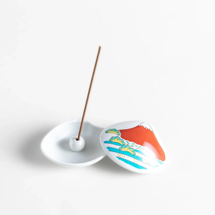 White ceramic seashell incense holder with red Mount Fuji and gold accents for elegant Japanese decor.