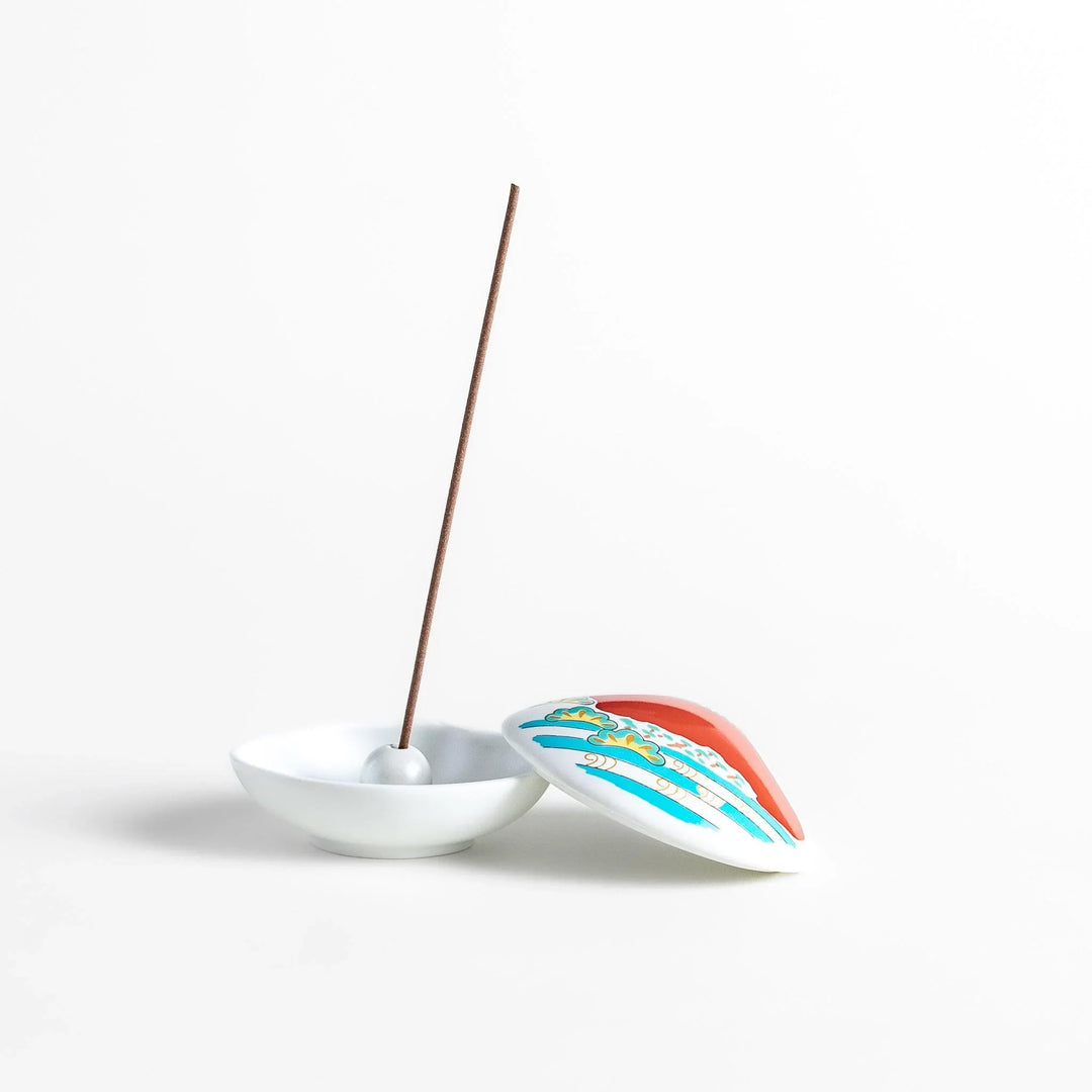White ceramic seashell incense holder with red Mount Fuji and gold accents for elegant Japanese decor.
