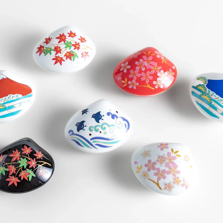 Decorative seashell-shaped incense holders with Japanese-inspired designs perfect for catching ash elegantly.
