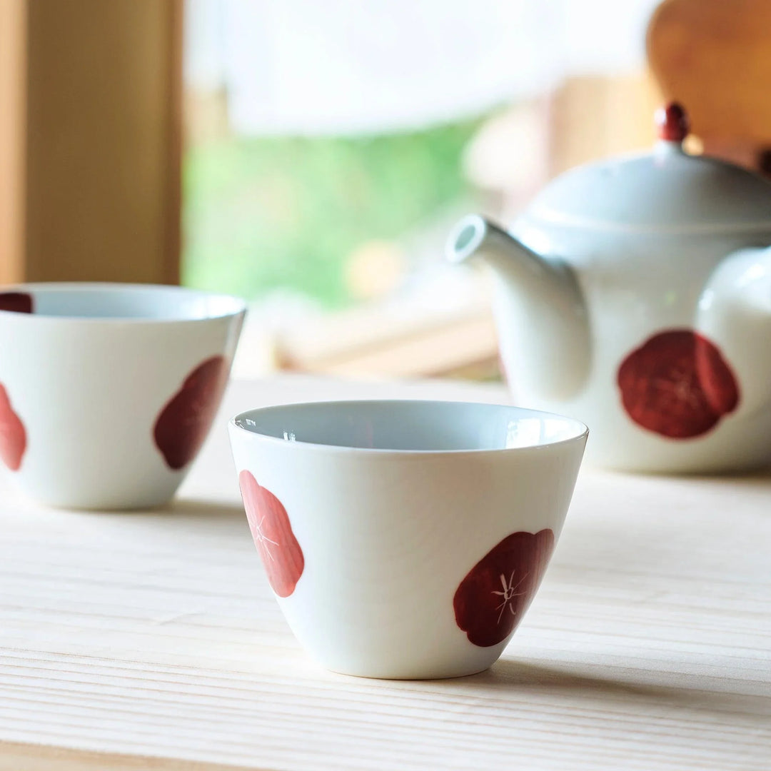 White teacup with a bold red design, offering a stylish and modern touch to your tea-drinking experience.