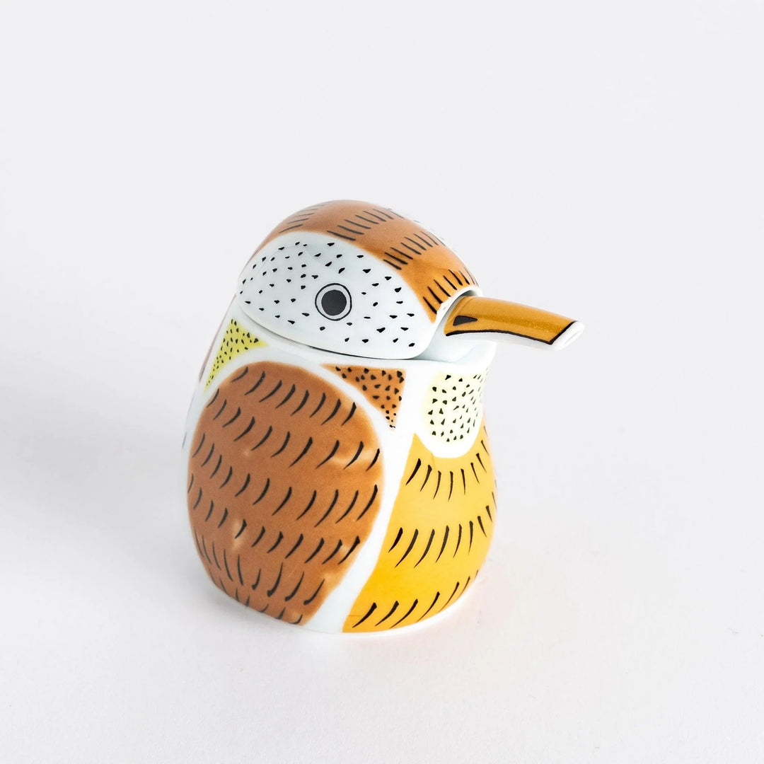 Ceramic soy sauce dispenser designed as a sparrow with a mix of brown, white, and orange tones and detailed feather patterns.